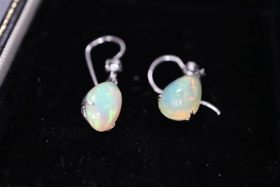 A pair of white metal and pear shaped opal and diamond set drop earrings, opal 12mm, gross 2.6 grams.